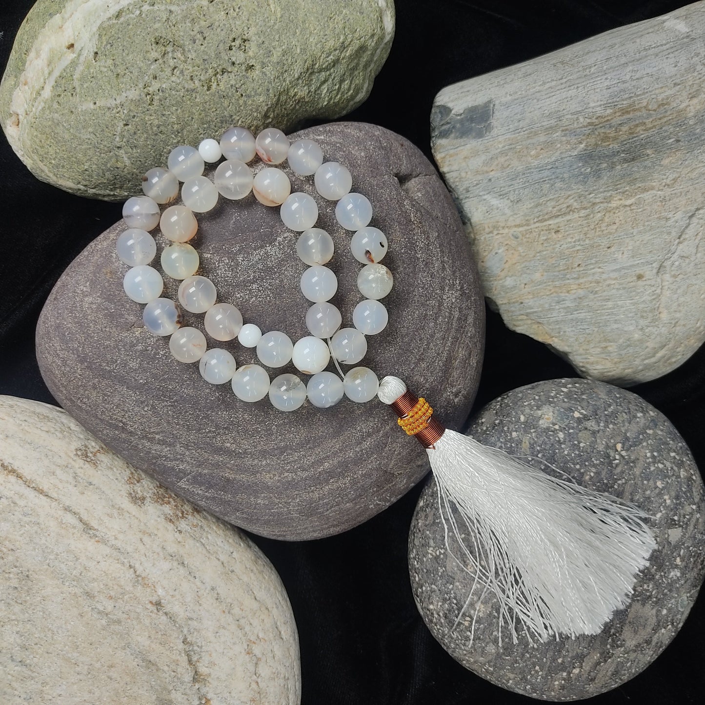 Beaded bracelet with tassel on stones